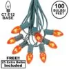 100 C7 String Light Set With Orange Bulbs On Green Wire
